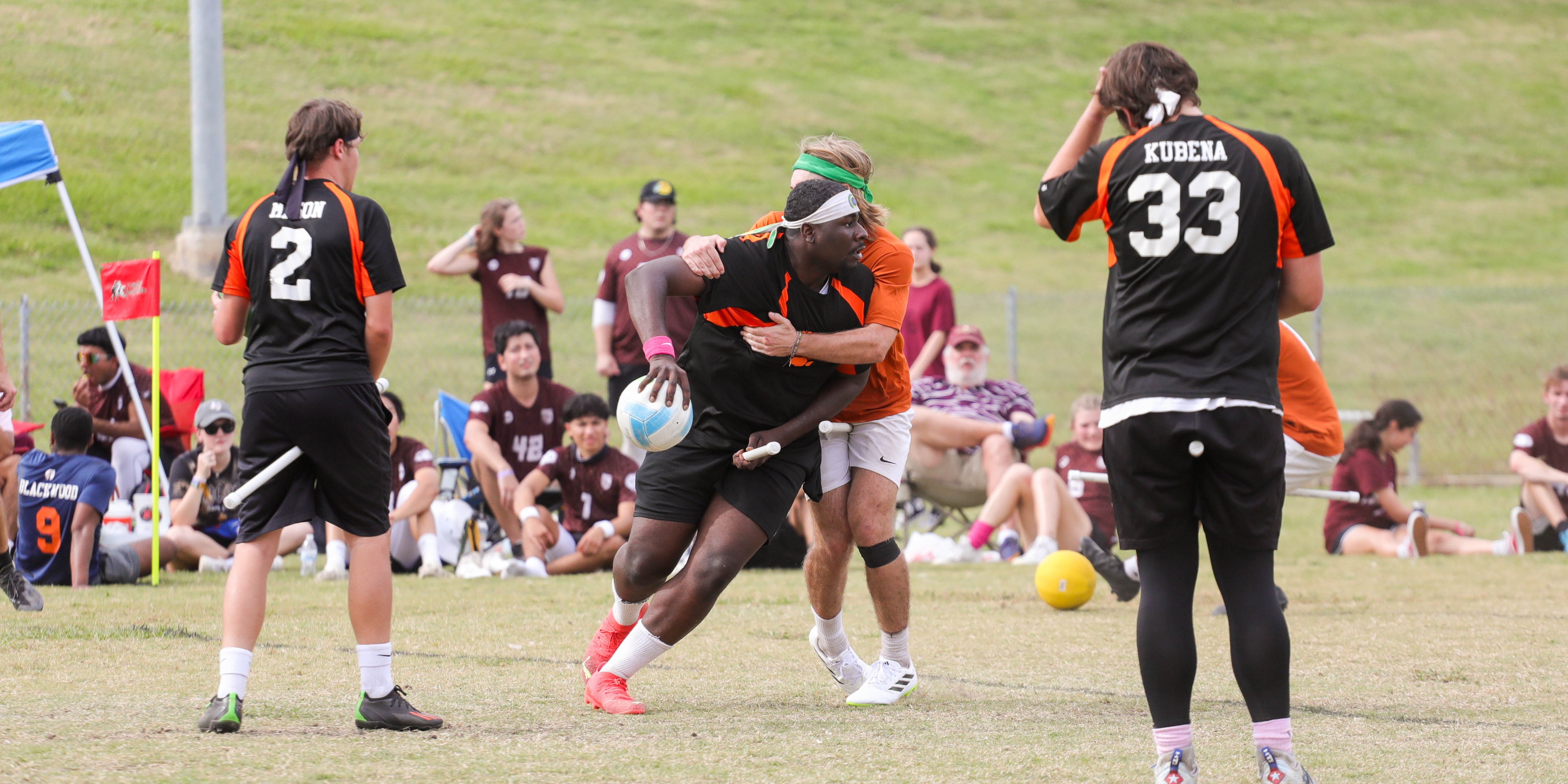 SHSU student playing defense in a quadball game on a sunny day.